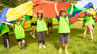 children playing with colourful parachute