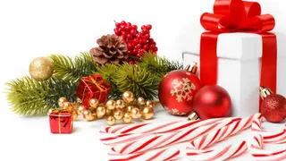 Christmas decorations including a present, baubles, candy canes, pine cones and some Christmas tree sprigs