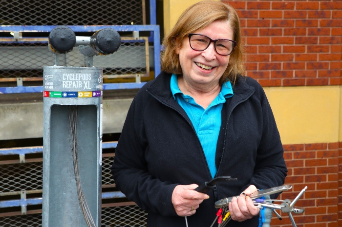 Cllr Sarah Nelmes, bike maintenance stand by Rickmansworth train station