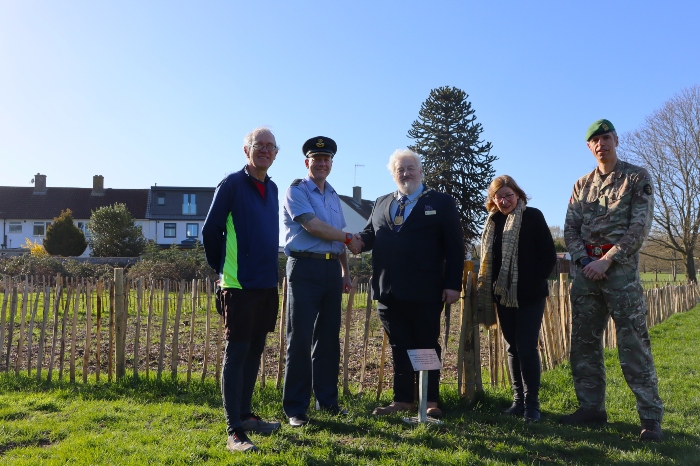 Cllr Stephen King shaking hands with Group Captain Neil Towers  by the plaque