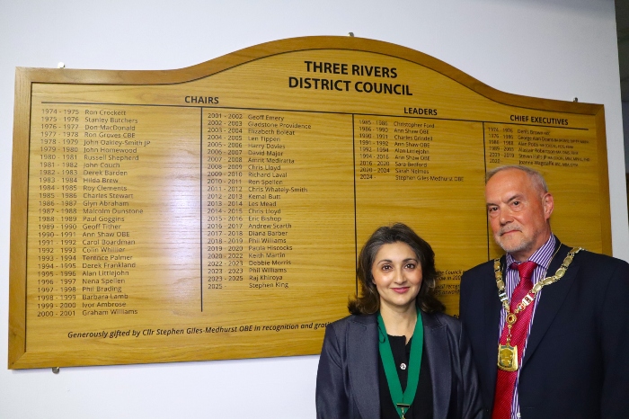 Cllr Keith Martin (Chair) and Cllr Reena Ranger (Vice-Chair) by the wooden board with the names of former Chairs, Leaders and Chief Executives