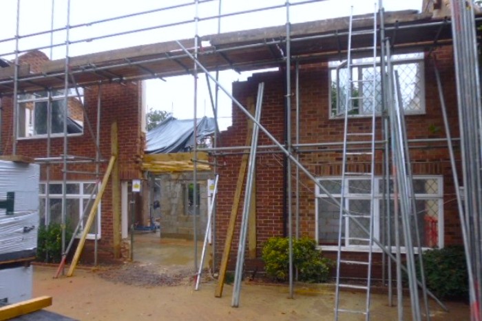 A demolished home with scaffolding still set up