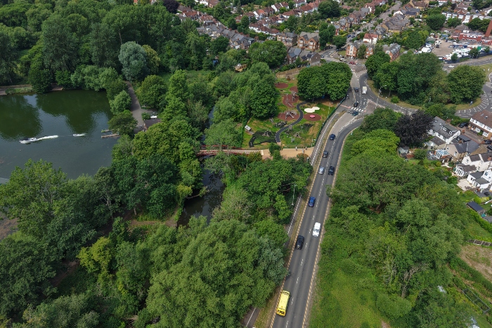 Aerial shot of Riverside Drive with cars on the road. A bit of Batchworth Lake on the left hand side with boats .