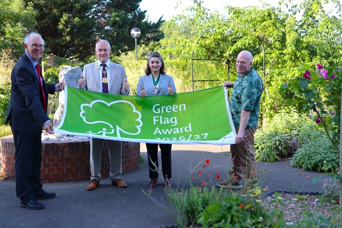 Councillors holding the Green Flag in the Rose Garden