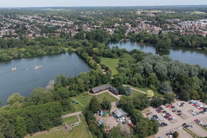 Bird's eye view of the two lakes and the cafe with car park at the Aquadrome. Rickmansworth town in the background