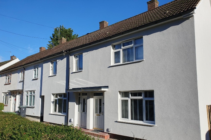 A row of homes paitned grey that have been retrofitted